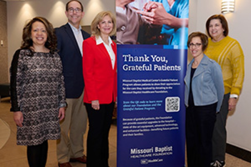 Members of the Missouri Baptist Healthcare Foundation stand around a poster thanking donors